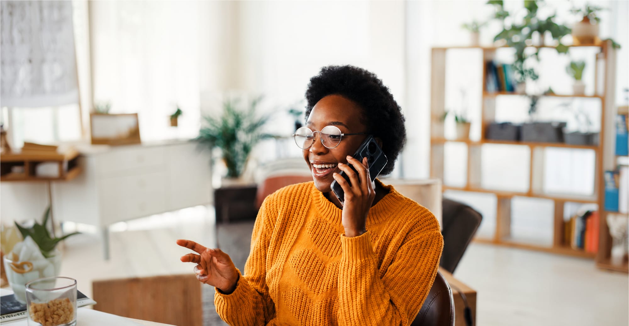 A Hagios Advisory client smiling during a phone conversation